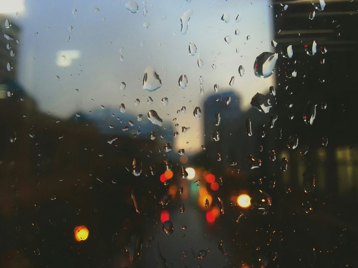 Rainy city street at night through a window