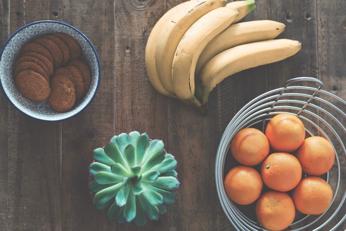 Flatlay of Bananas, Oranges, Cookies, and Succulent
