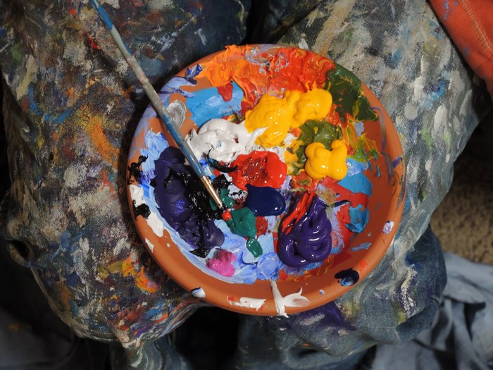 Artist's paint palette with brush and colorful paints