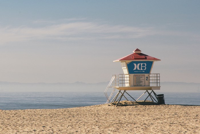 Lifeguard tower on a sandy beach with ocean and sky