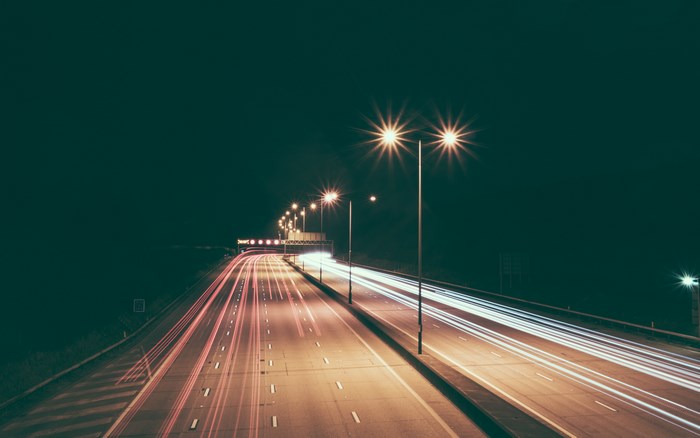 Long exposure of a highway at night with light trails