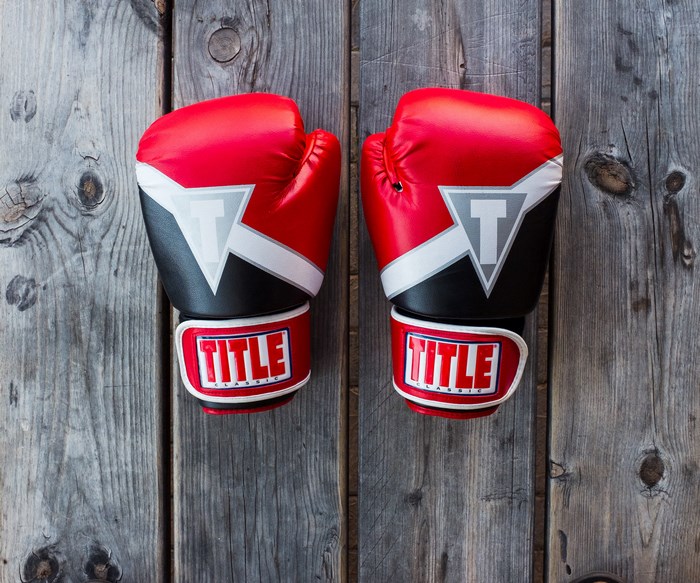 TITLE Classic Red Boxing Gloves on Wooden Background