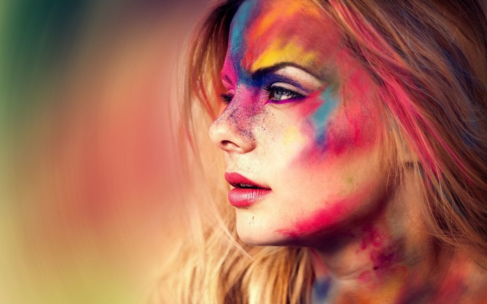 Woman with colorful face paint and blonde hair