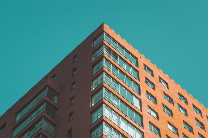Orange building with geometric windows against blue sky