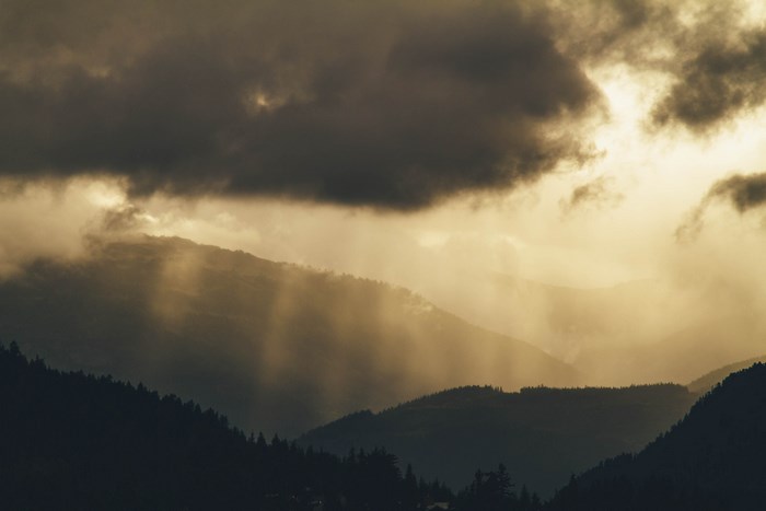 Sunlight rays through clouds over Whistler mountains