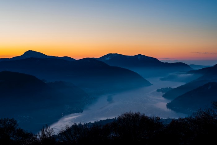 Mountain valley with lake at sunset
