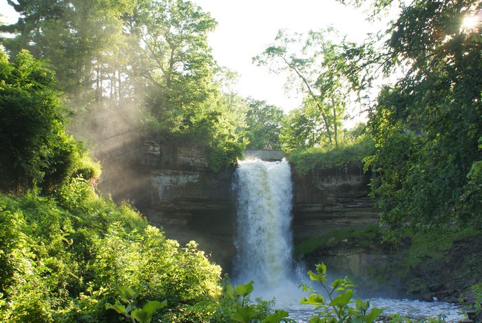 Minnehaha Falls in summer with sunlight and mist