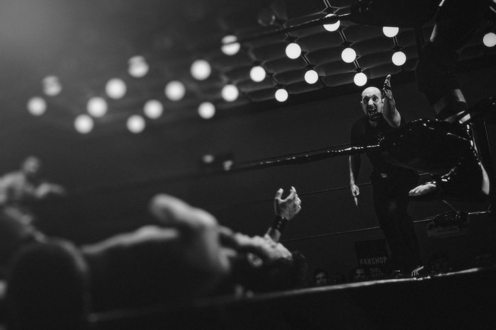Wrestler yelling at fallen opponent in a ring