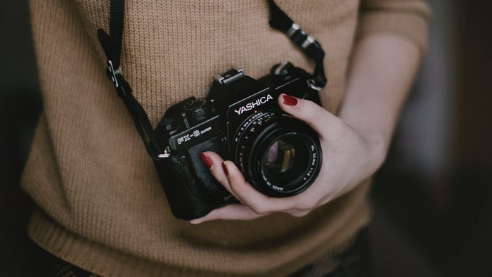 Woman holding a Yashica FX-3 Super film camera