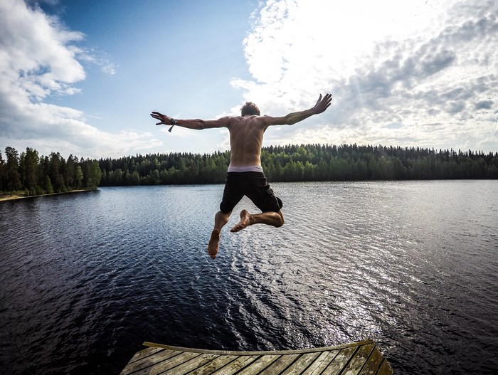 Man jumping into a lake in Finland