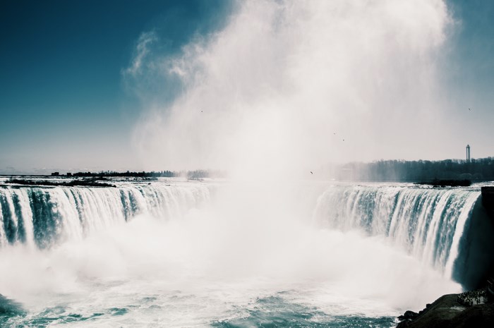 Niagara Falls with mist and blue sky