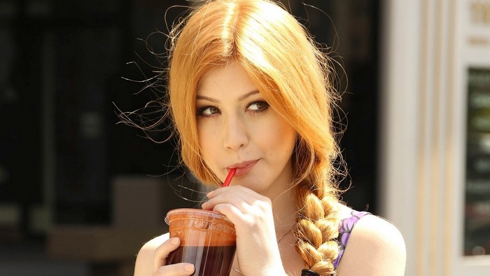 Katherine McNamara drinking from a cup