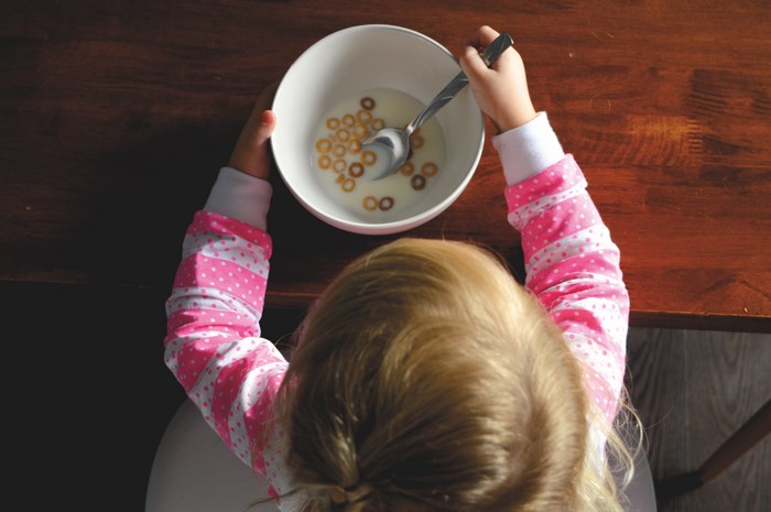 Child eating cereal with a spoon