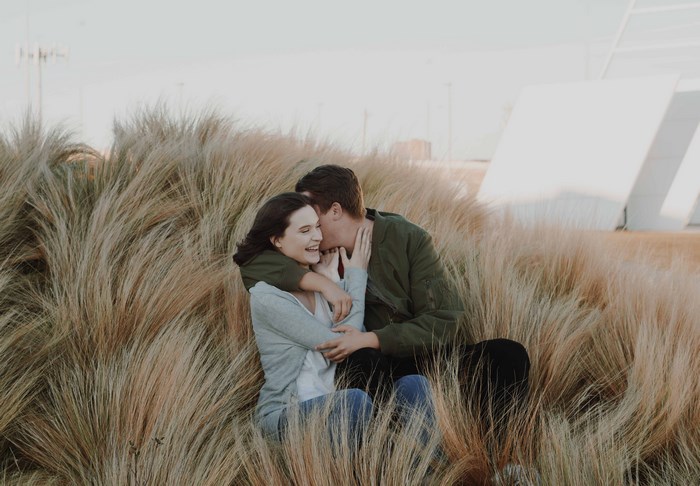 Couple sitting in tall grass