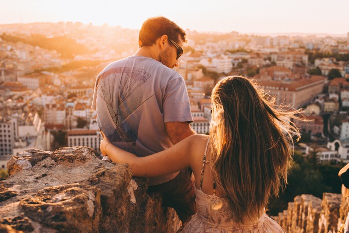 Couple enjoying a sunset cityscape view