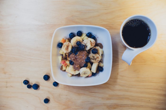 Bowl of fruit with coffee