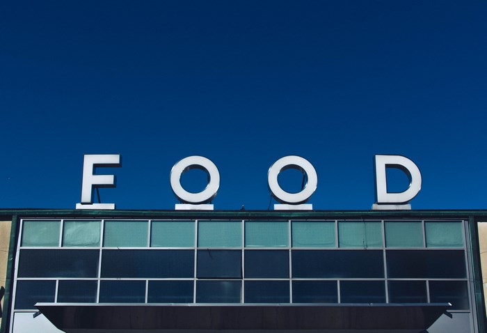 FOOD sign on a building against a blue sky