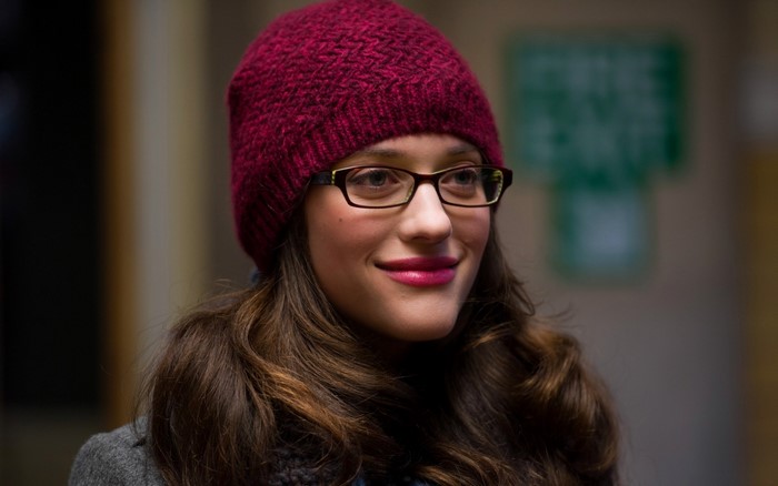 Kat Dennings wearing a red hat and glasses