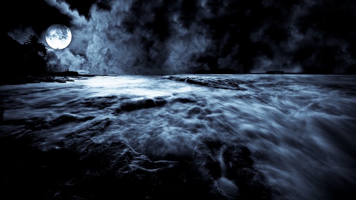 Night sea under a full moon with clouds