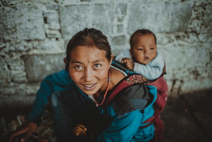 Woman carrying a baby on her back