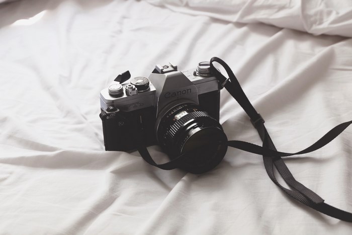 Canon Analog Camera on White Sheets