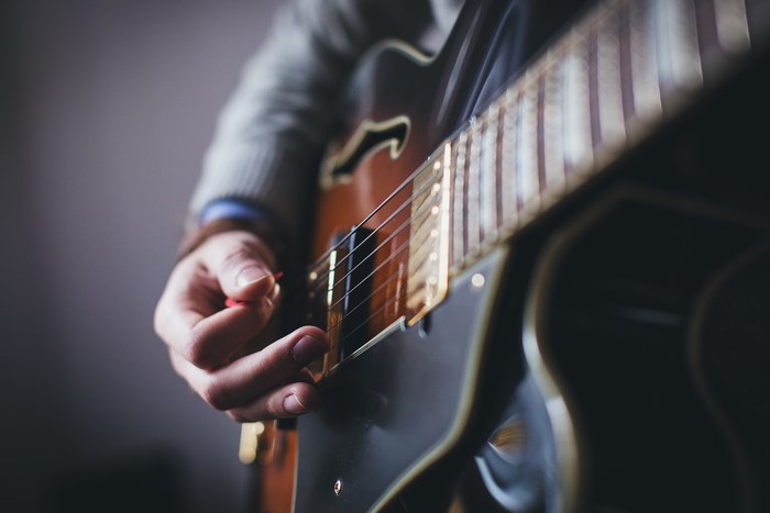 Close-up of a person playing a guitar