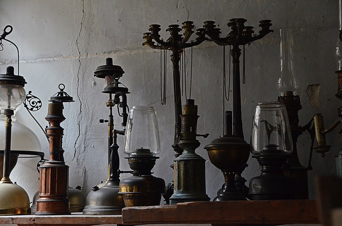 Collection of old oil lamps and candle holders