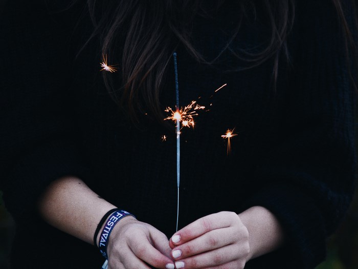 Woman holding a sparkler at a festival