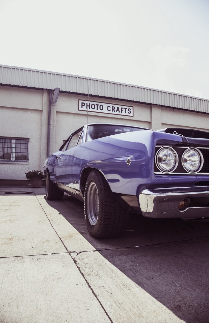 Purple Dodge Coronet parked in front of Photo Crafts building