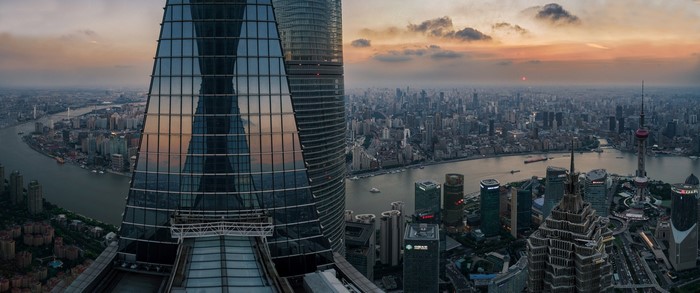 Shanghai cityscape panorama at sunset with skyscrapers and river