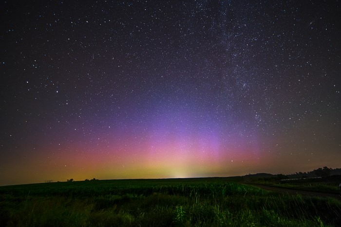 Aurora Borealis over a grassy field at night