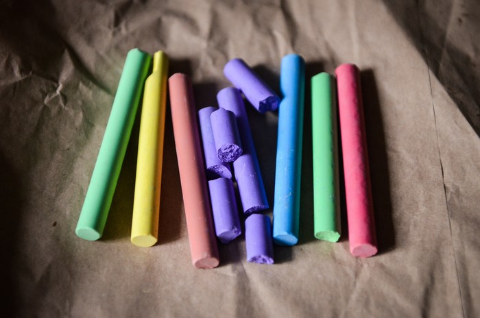 Colorful chalk sticks on brown paper
