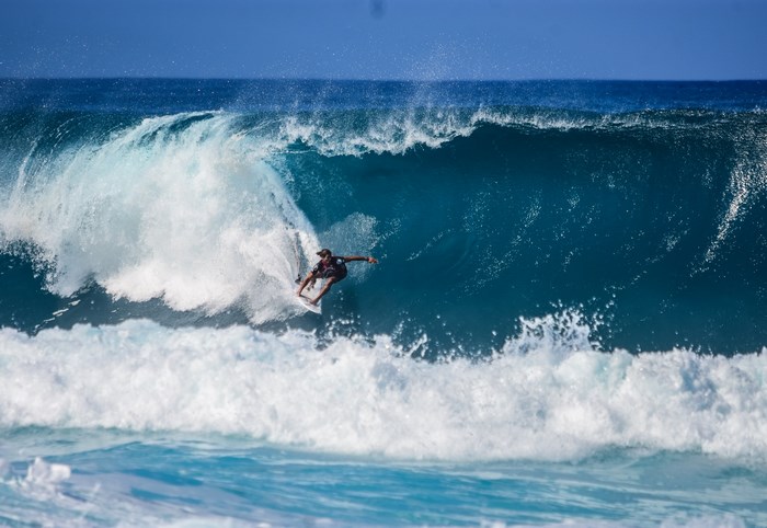 Surfer riding a large wave at Pipeline, Oahu