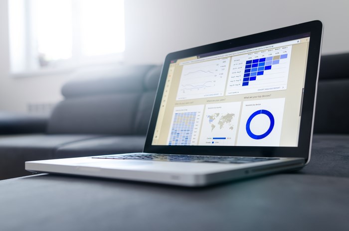Laptop displaying analytics report on a couch