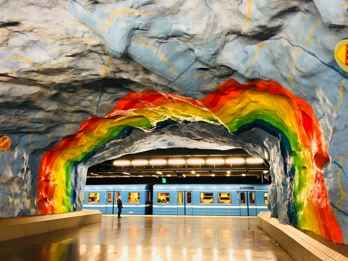 Rainbow tunnel at Stockholm subway station with train