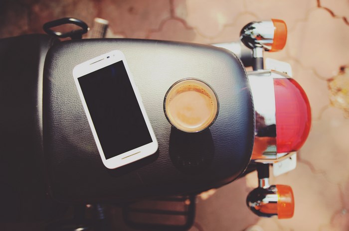 Motorcycle seat with coffee and smartphone