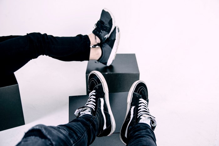 Vans sneakers on feet resting on cubes