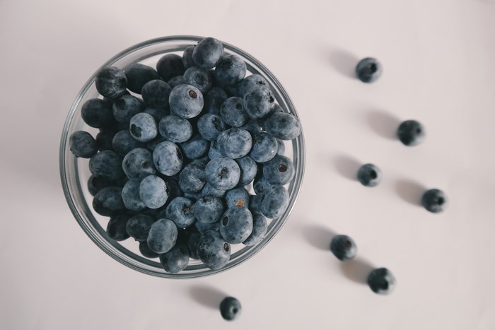 Blueberries in a glass bowl on a white table
