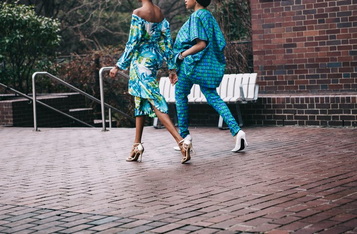 Two women in African print fashion walking