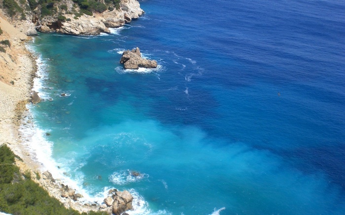 Rocky coastline with turquoise and deep blue ocean