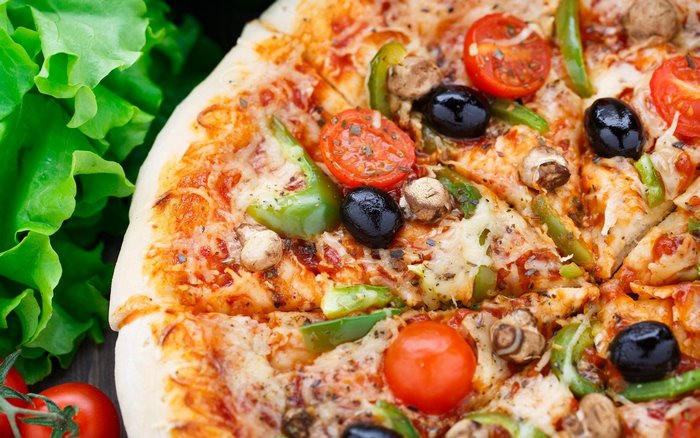Vegetable pizza with olives, tomatoes, and mushrooms