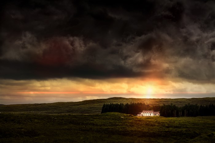 White house in Scotland during a stormy sunset