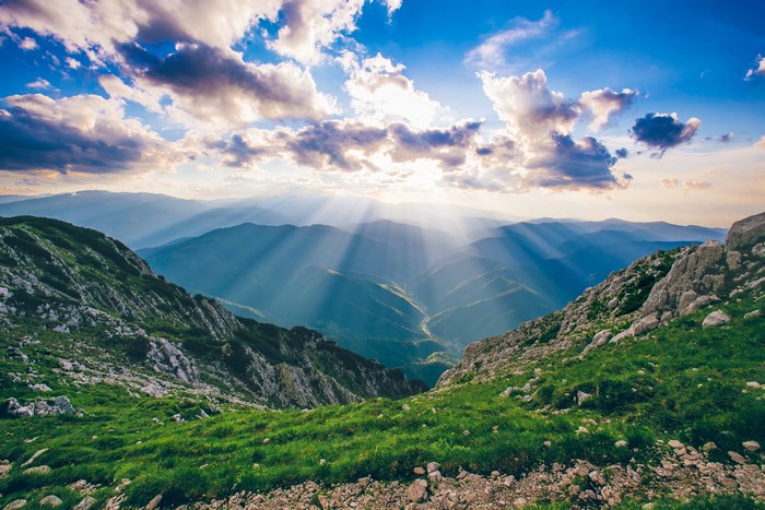 Sunbeams over Piatra Craiului mountains in Romania