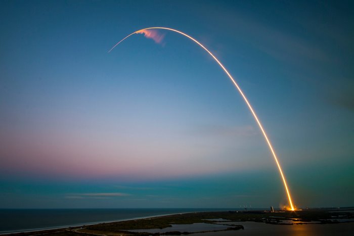 SpaceX Falcon 9 rocket launch at dusk