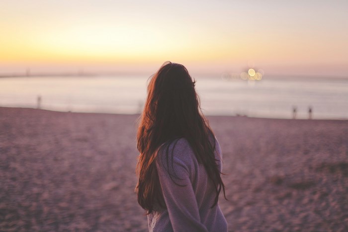 Woman on beach at sunset