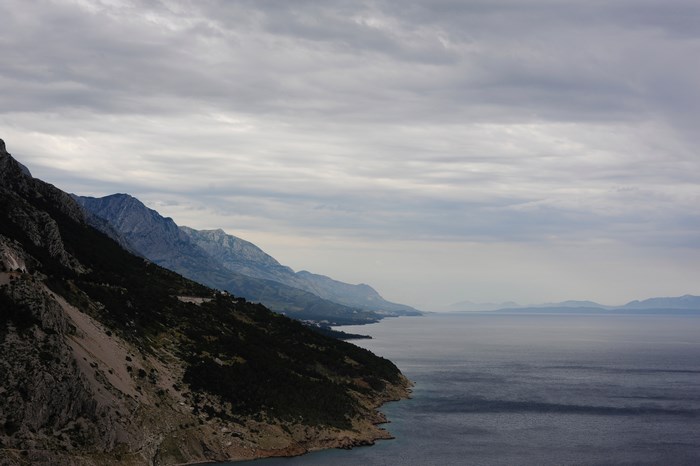 Cloudy sky over mountains and sea coastline