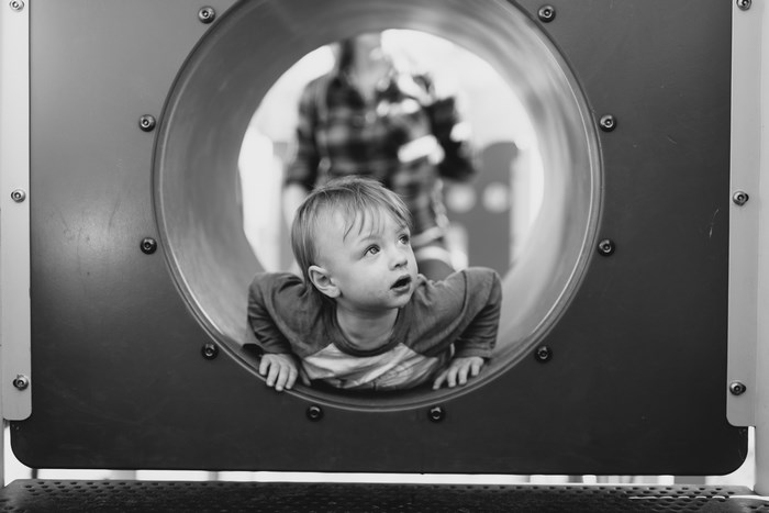 Boy in a playground tunnel