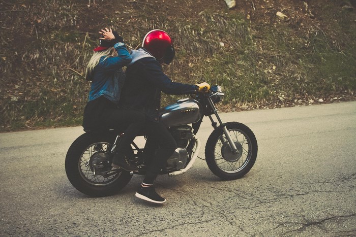Couple riding a motorcycle on a road