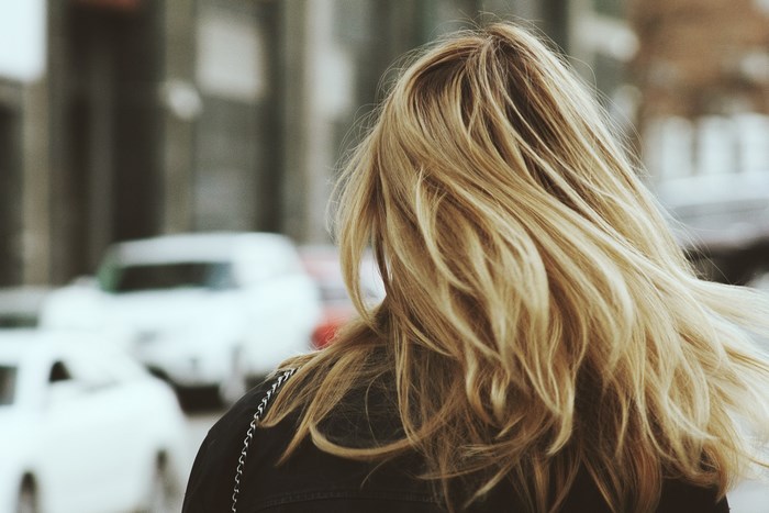 Woman with blonde hair on a city street
