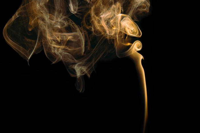 Gold smoke trails against a black background